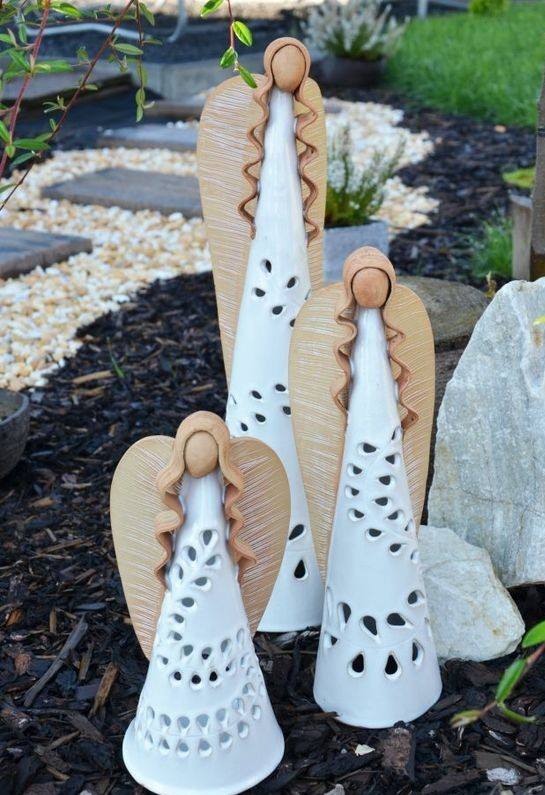 Glazed clay angel in garden.