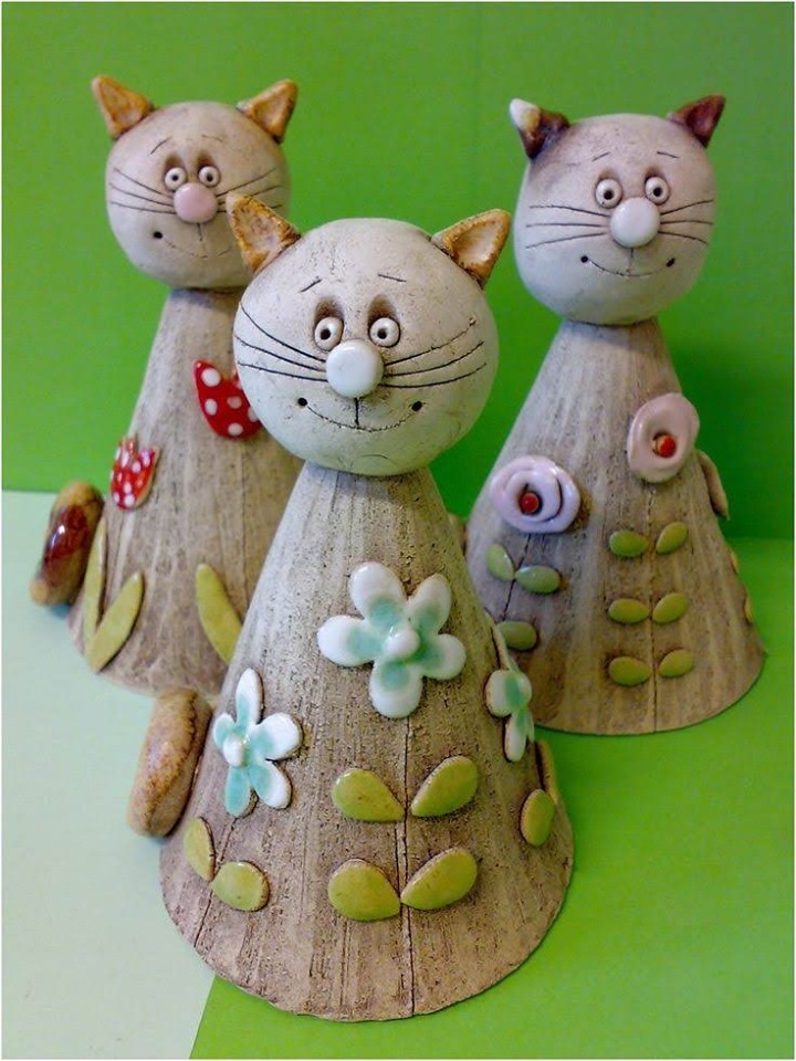 Ceramic clay cats with flower decorations.