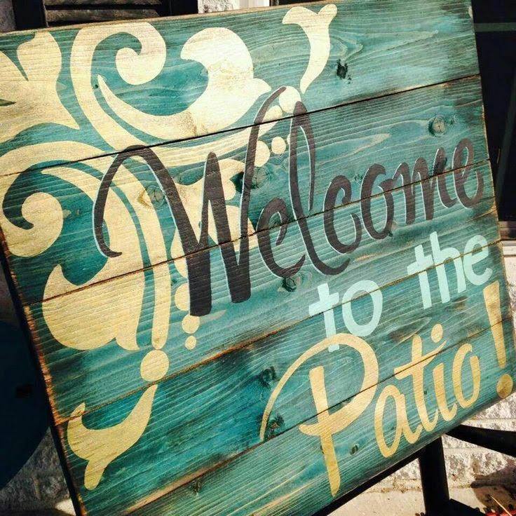 Painted pallet wood sign that reads "Welcome to the Patio".