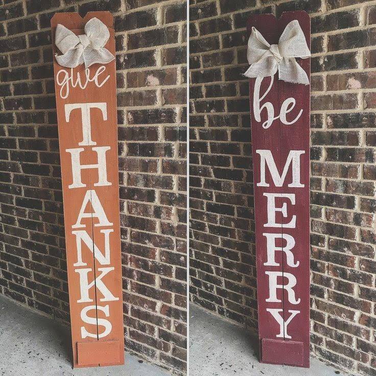 Two painted signs. One says thanks and one says be merry.