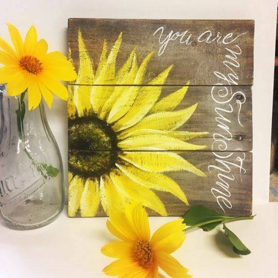 Hand-painted sunflower on recycled pallet boards.