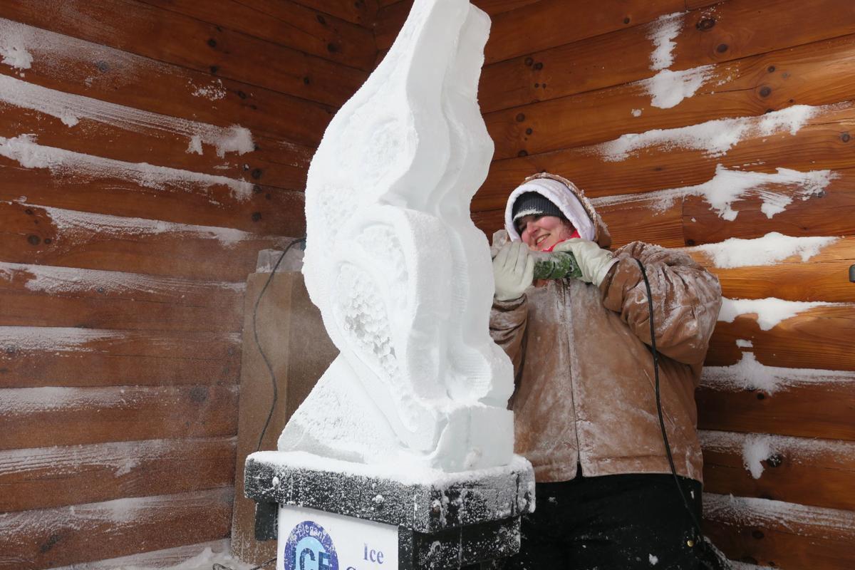 Person using ice carving tool on block of ice.